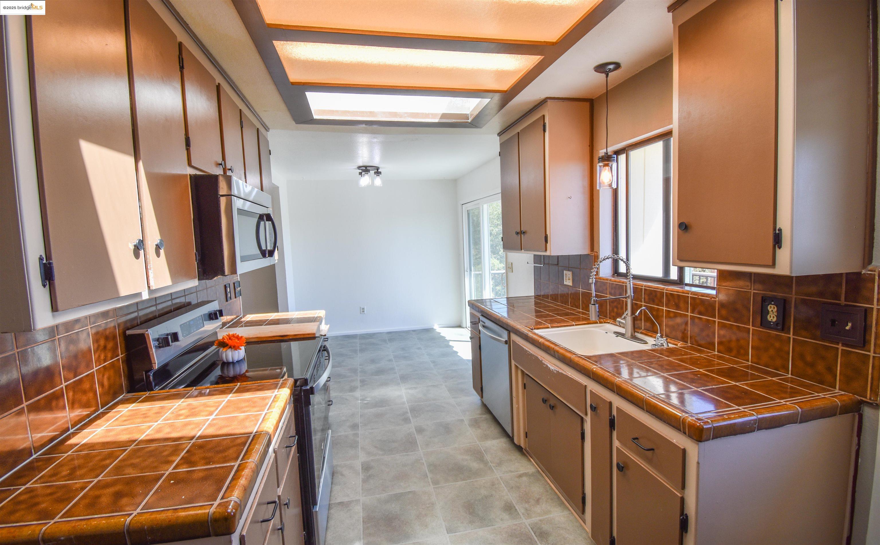 21850 Phoenix Lake Road Sonora, CA 95370 - Photo 17 of 39 a kitchen with stainless steel appliances granite countertop a sink and a refrigerator
