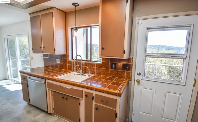 a kitchen with a stove sink and cabinets