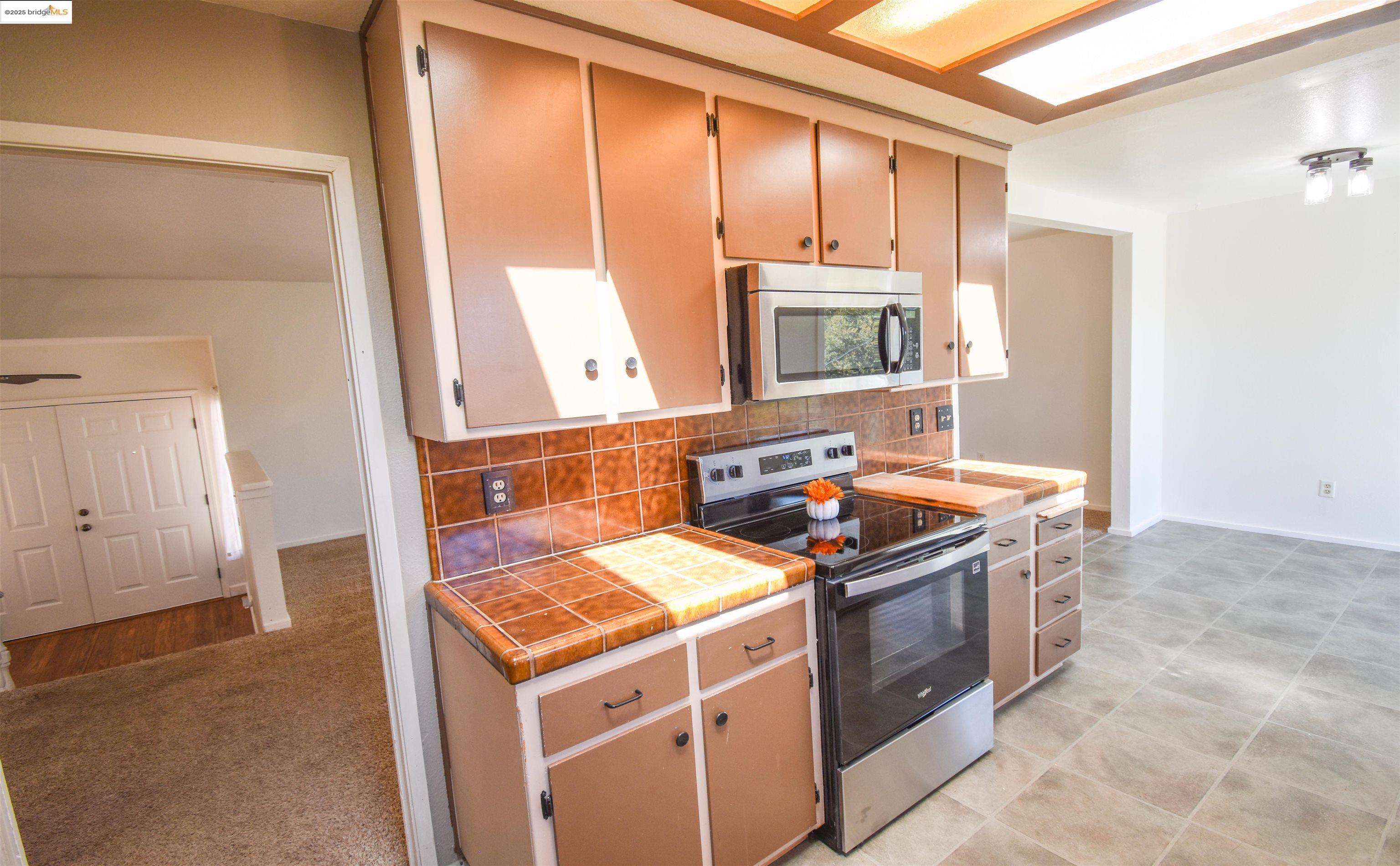 21850 Phoenix Lake Road Sonora, CA 95370 - Photo 19 of 39 a kitchen with a stove sink and cabinets