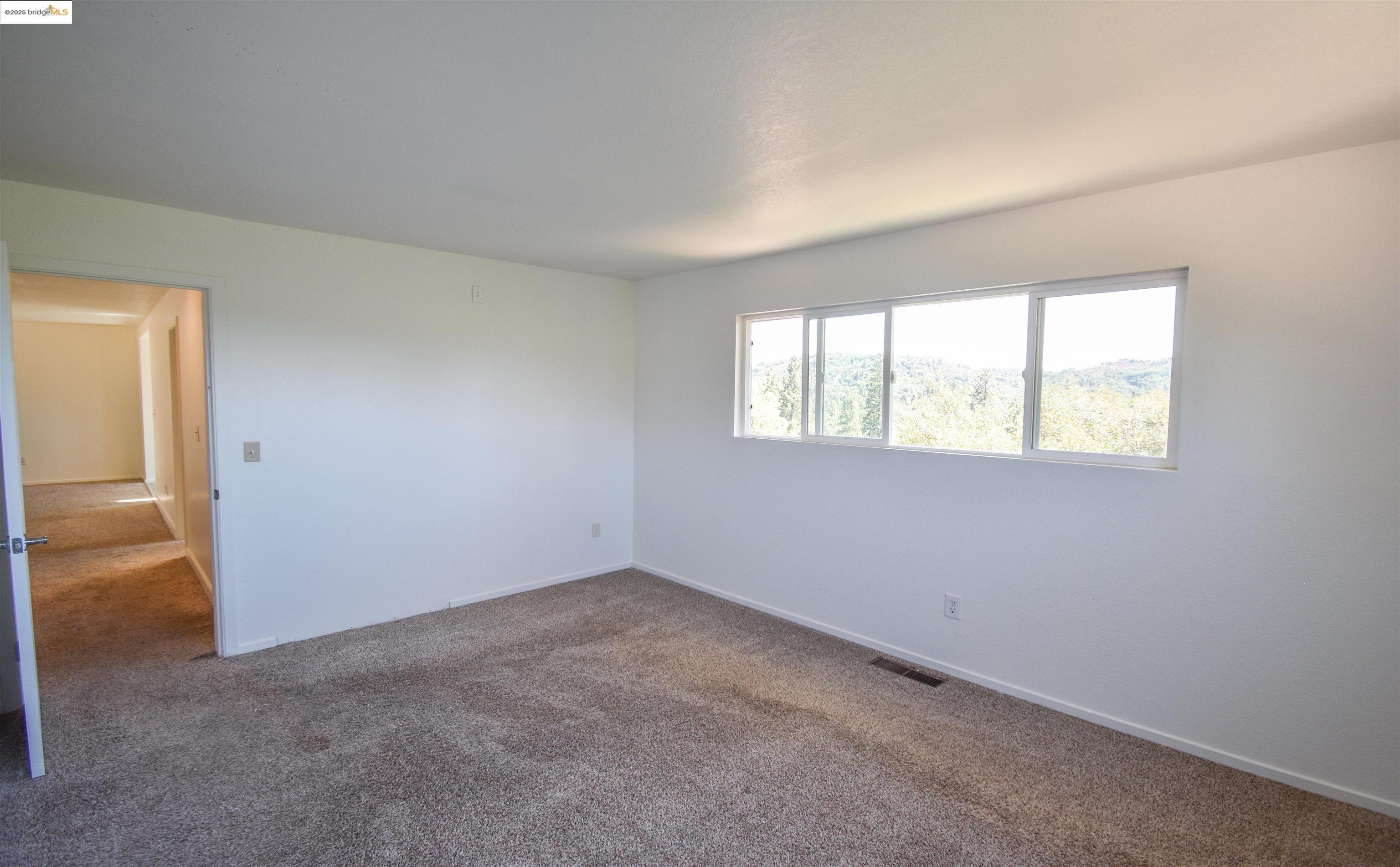 21850 Phoenix Lake Road Sonora, CA 95370 - Photo 22 of 39 an empty room with windows