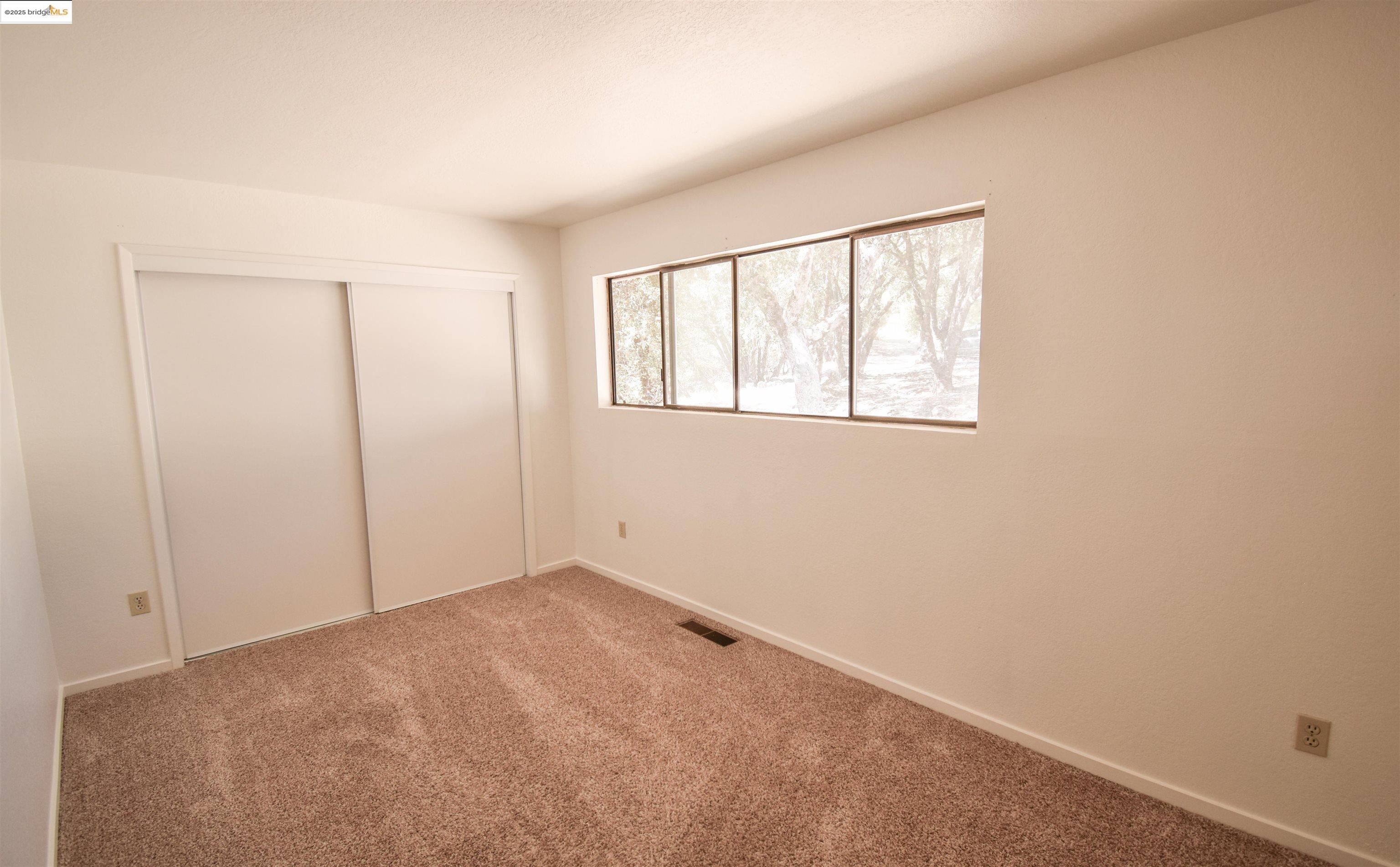 21850 Phoenix Lake Road Sonora, CA 95370 - Photo 24 of 39 an empty room with windows