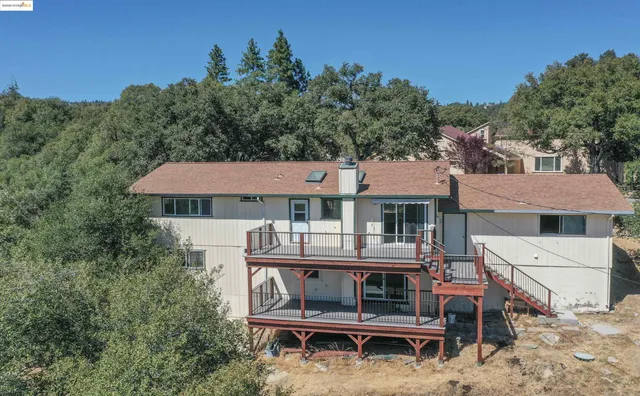 an aerial view of a house with table and chairs