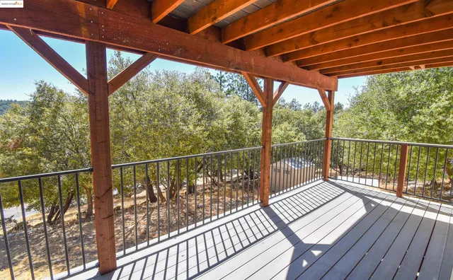 a view of a two chair and a table in the balcony
