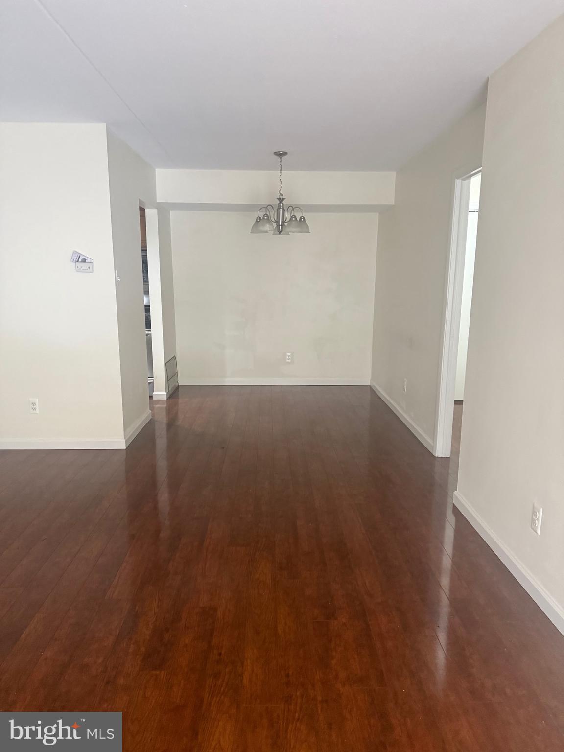 76 Old Forge Crossing, Unit 76 Devon, PA 19333 - Photo 4 of 17 an empty room with wooden floor ceiling fan and windows