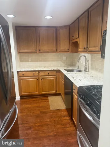 a kitchen with granite countertop cabinets stainless steel appliances and sink
