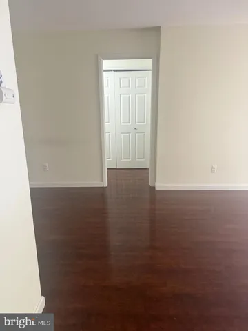 an empty room with a fan and a window