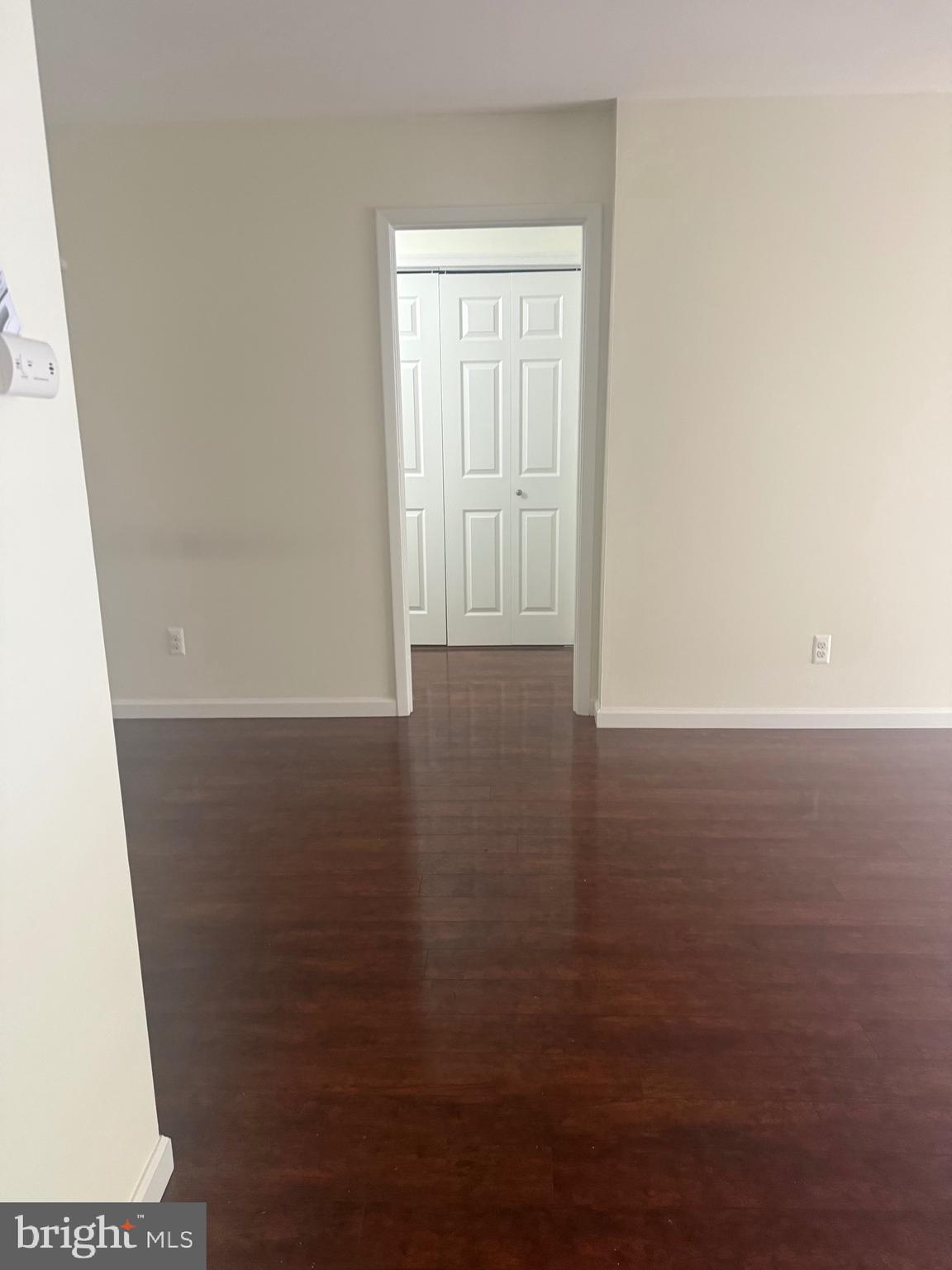 76 Old Forge Crossing, Unit 76 Devon, PA 19333 - Photo 9 of 17 an empty room with wooden floor and windows