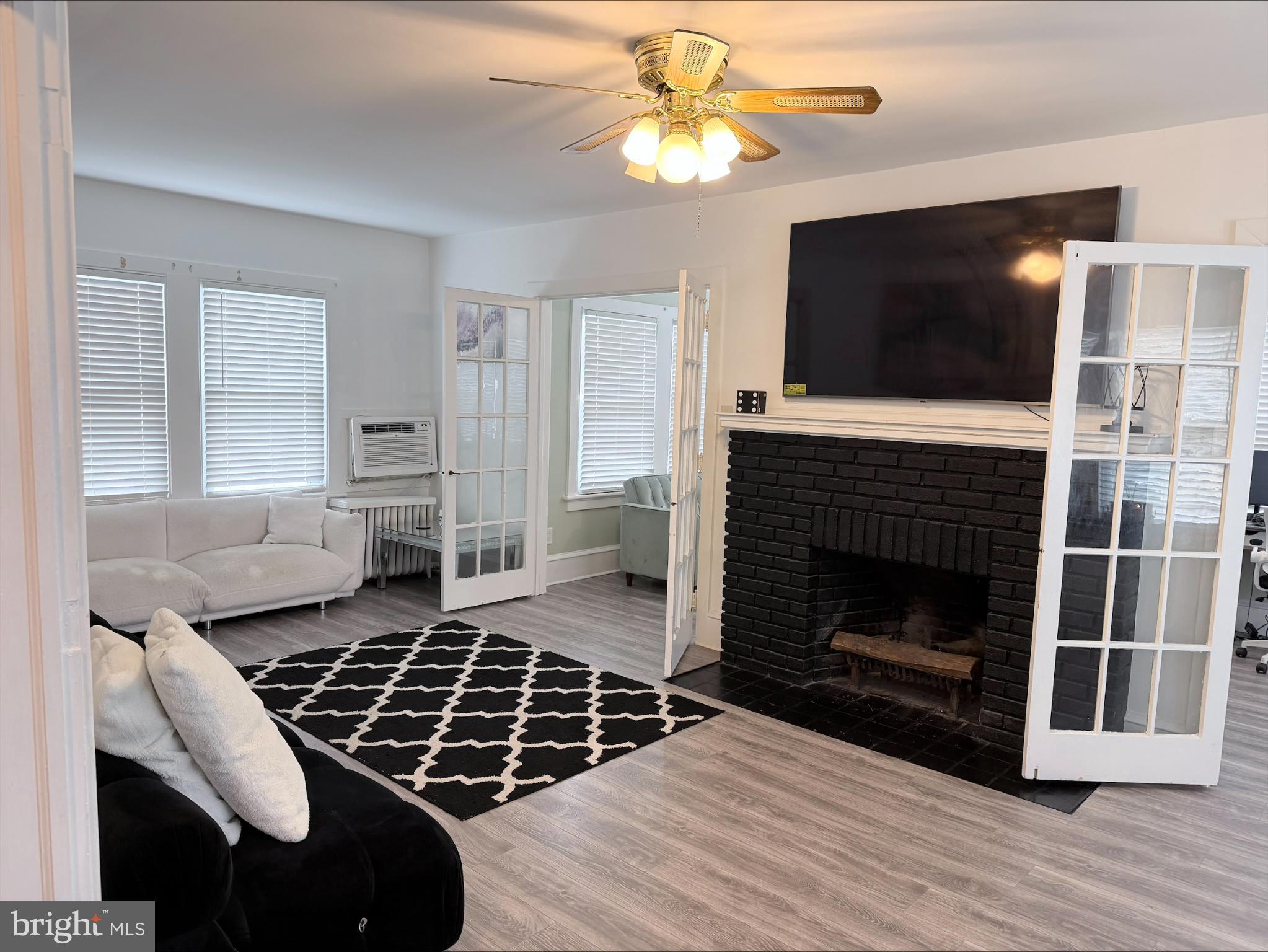 283 West Commerce St Extension Bridgeton, NJ 08302 - Photo 2 of 27 a living room with furniture a flat screen tv and a fireplace