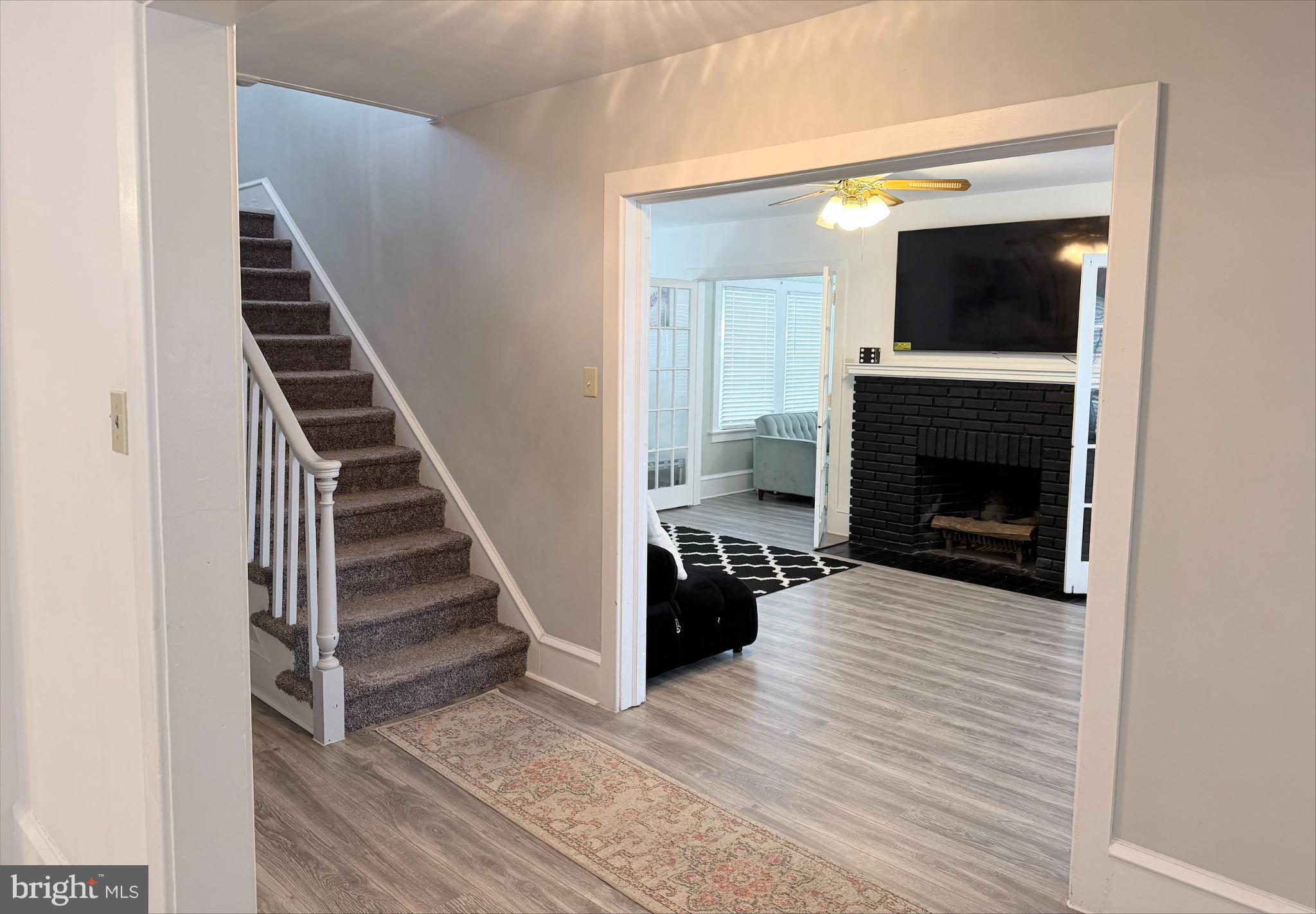 283 West Commerce St Extension Bridgeton, NJ 08302 - Photo 8 of 27 a view of a livingroom with wooden floor and a fireplace