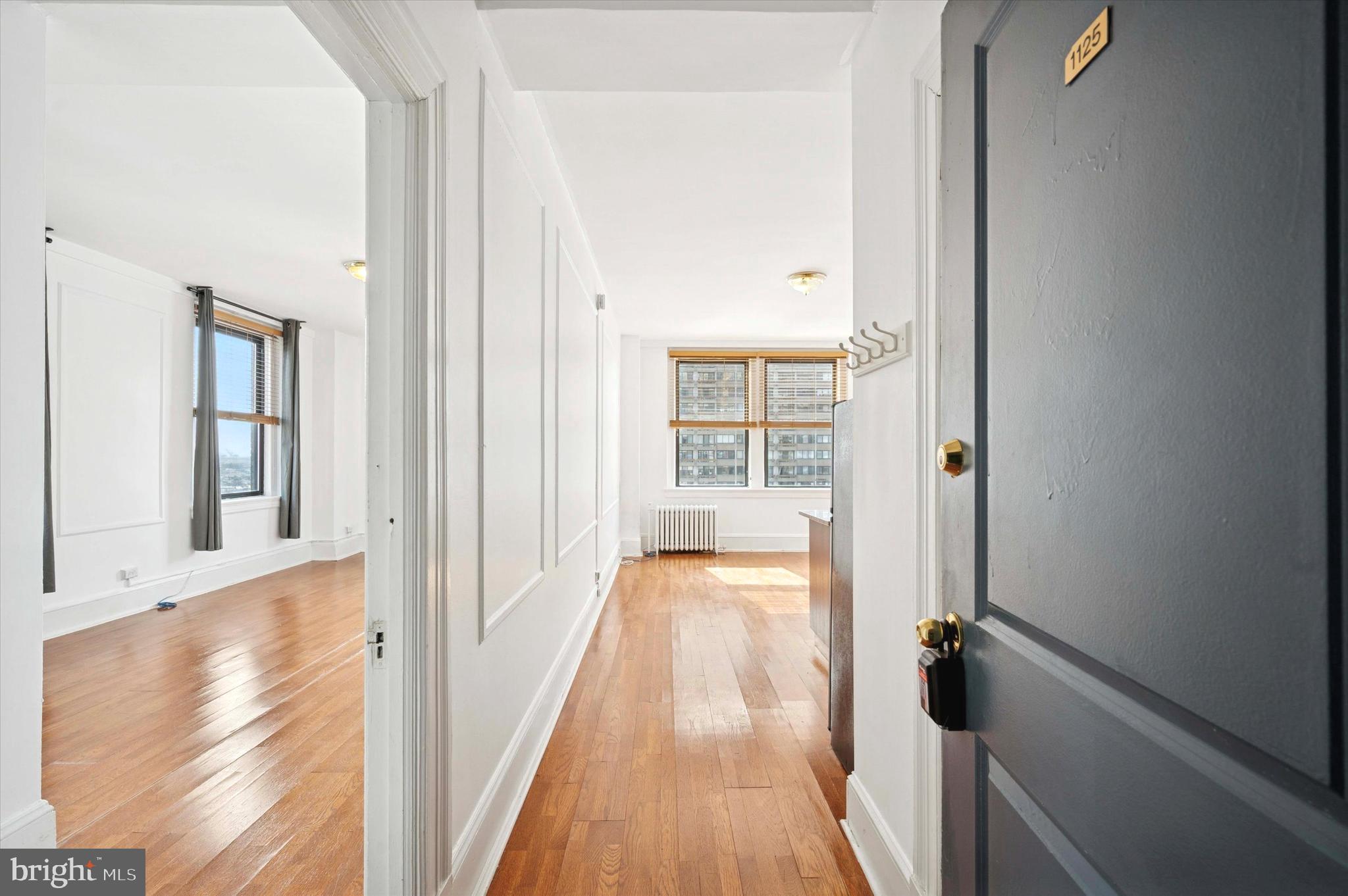 1324 Locust Street, Unit 1125 Philadelphia, PA 19107 - Photo 12 of 16 a view of a hallway with wooden floor and staircase