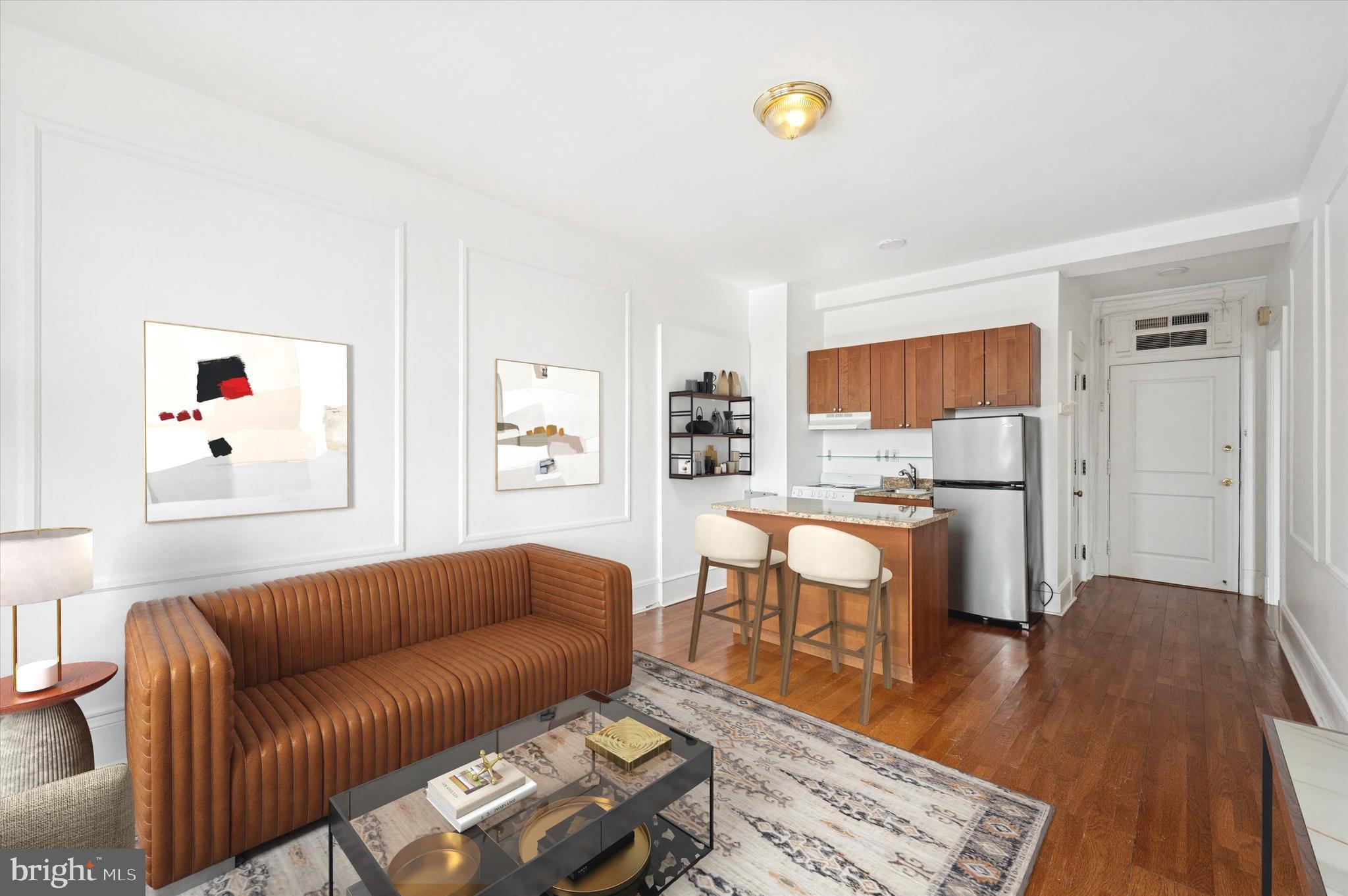 1324 Locust Street, Unit 1125 Philadelphia, PA 19107 - Photo 2 of 16 a living room with furniture and a wooden floor