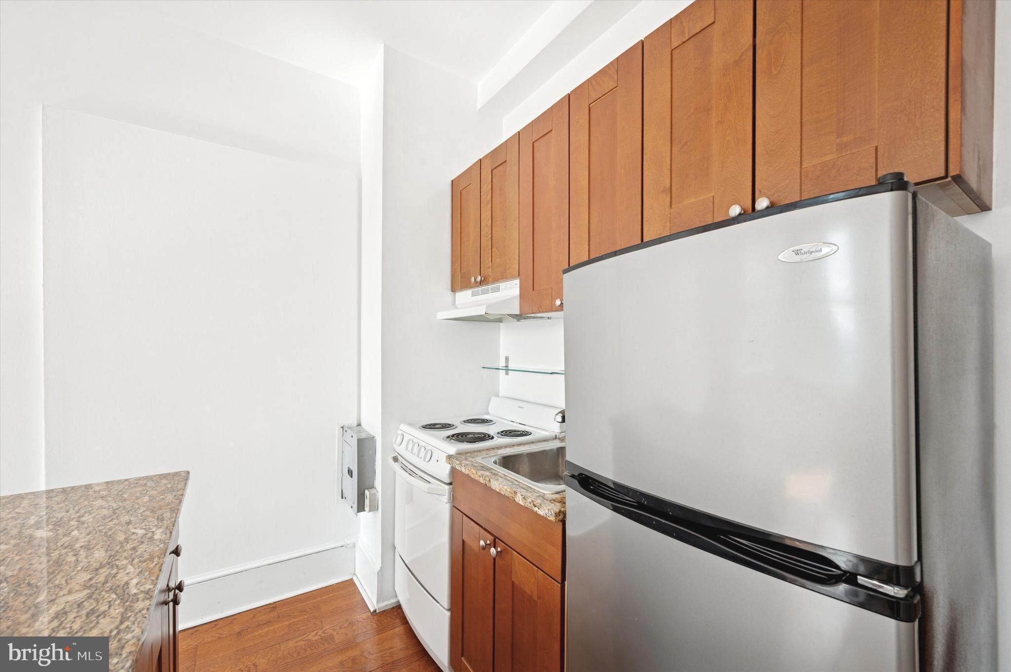 1324 Locust Street, Unit 1125 Philadelphia, PA 19107 - Photo 4 of 16 a kitchen with a refrigerator and a stove