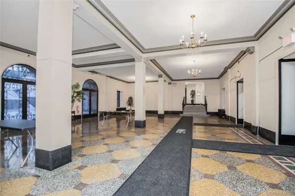 a dining room with wooden floor and chandelier