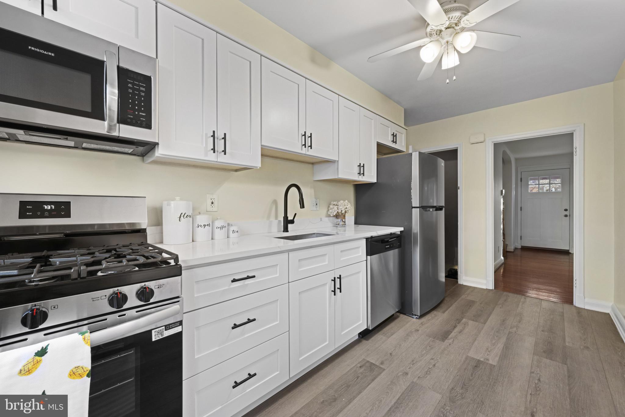 132 Overbrook Road Baltimore, MD 21212 - Photo 11 of 36 a kitchen with stainless steel appliances granite countertop a stove a refrigerator and a microwave