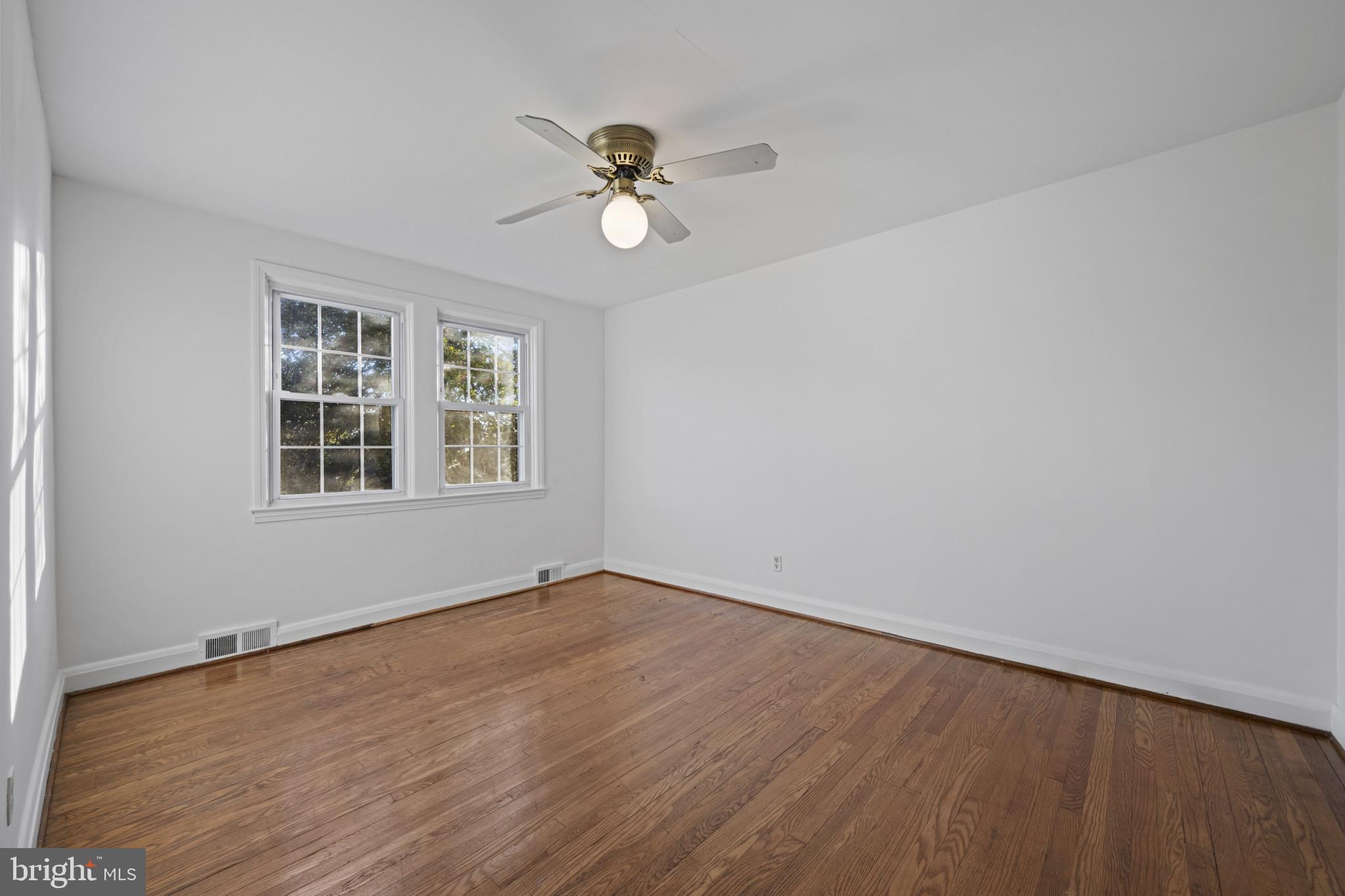 132 Overbrook Road Baltimore, MD 21212 - Photo 17 of 36 a view of empty room with wooden floor and fan