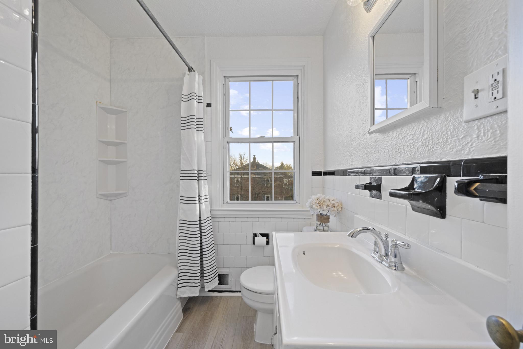 132 Overbrook Road Baltimore, MD 21212 - Photo 21 of 36 a bathroom with a sink a toilet and shower