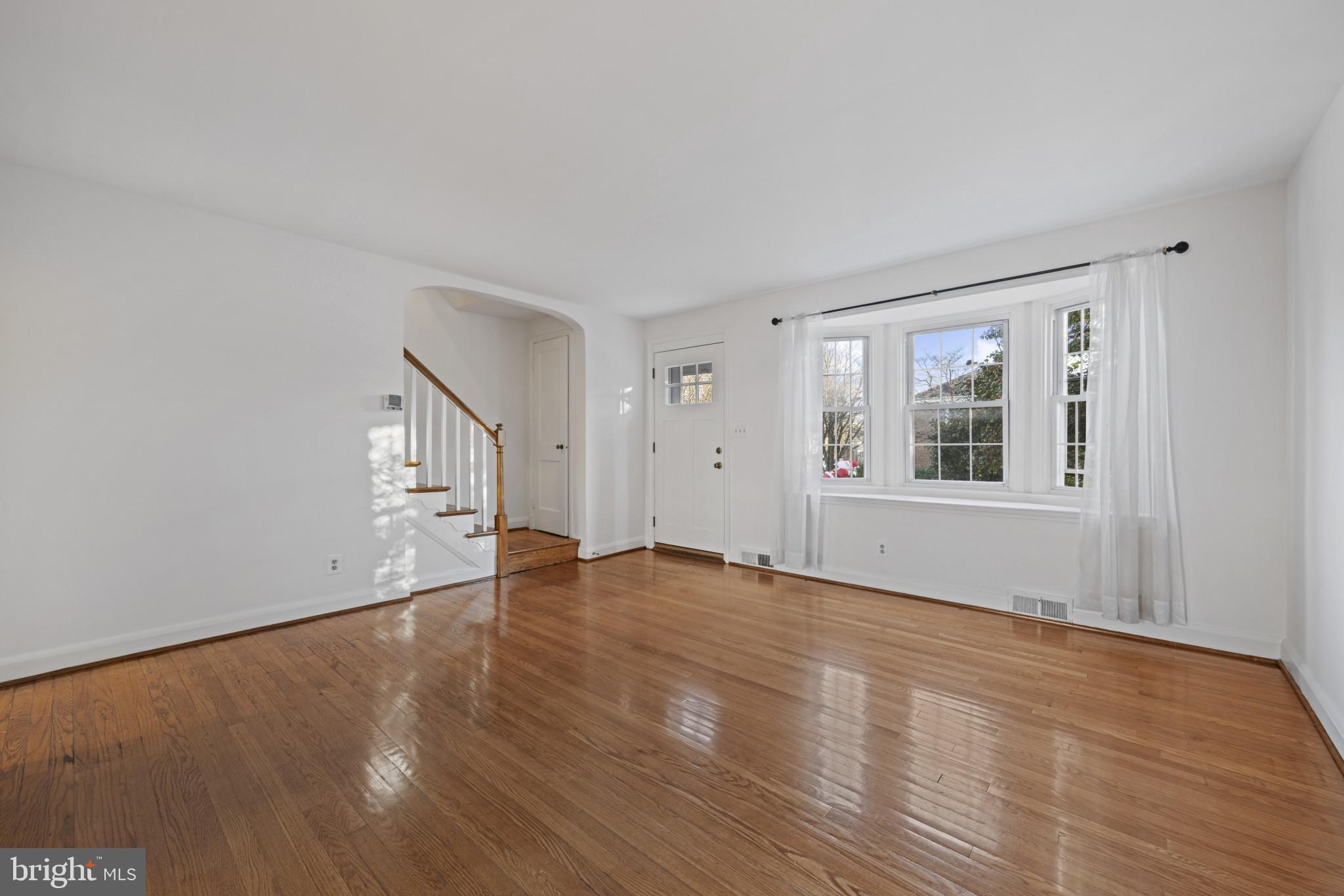 132 Overbrook Road Baltimore, MD 21212 - Photo 5 of 36 a view of empty room with wooden floor and fan
