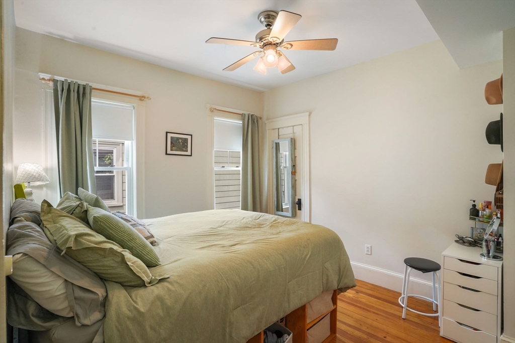 37 Dimick Street, Unit 3 Somerville, MA 02143 - Photo 7 of 12 a bedroom with a bed and a chandelier