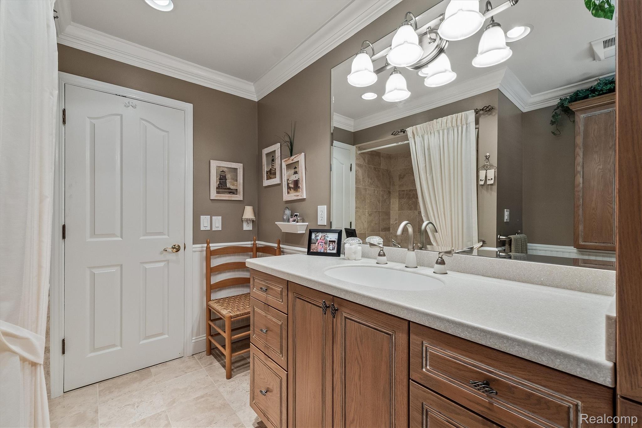 1662 Sumac Drive Rochester, MI 48309 - Photo 25 of 38 Bathroom vanity featuring a light-toned countertop with an integrated sink and brushed nickel fixtures