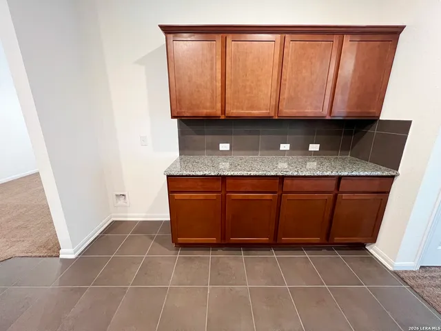 a view of a room with wooden floor and windows