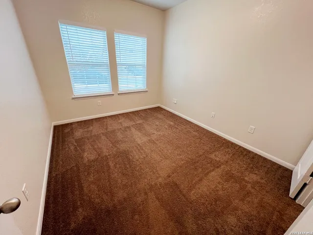 an empty room with an entrance to other room