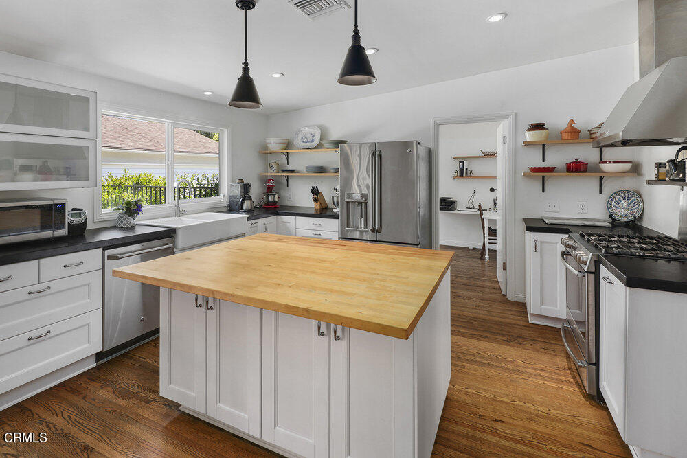 3657 Thorndale Road Pasadena, CA 91107 - Photo 13 of 44 a kitchen with kitchen island a counter top space a sink a stove and a window