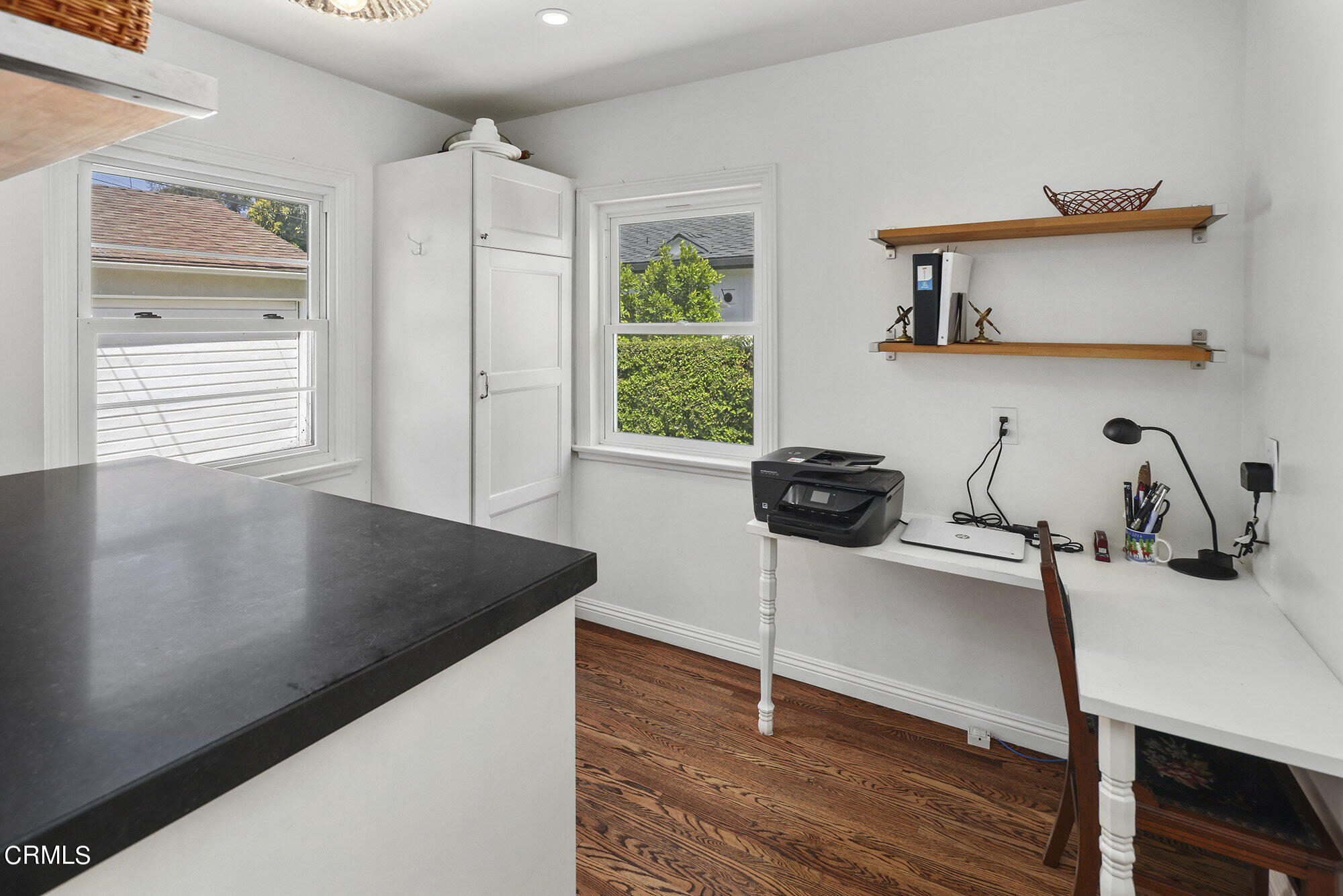 3657 Thorndale Road Pasadena, CA 91107 - Photo 16 of 44 a view of a kitchen with kitchen island a sink wooden floor and a large window