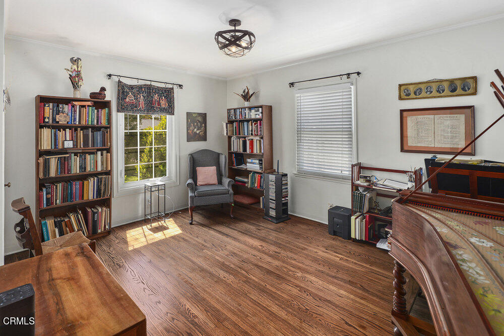 3657 Thorndale Road Pasadena, CA 91107 - Photo 35 of 44 a bedroom with furniture and a book shelf
