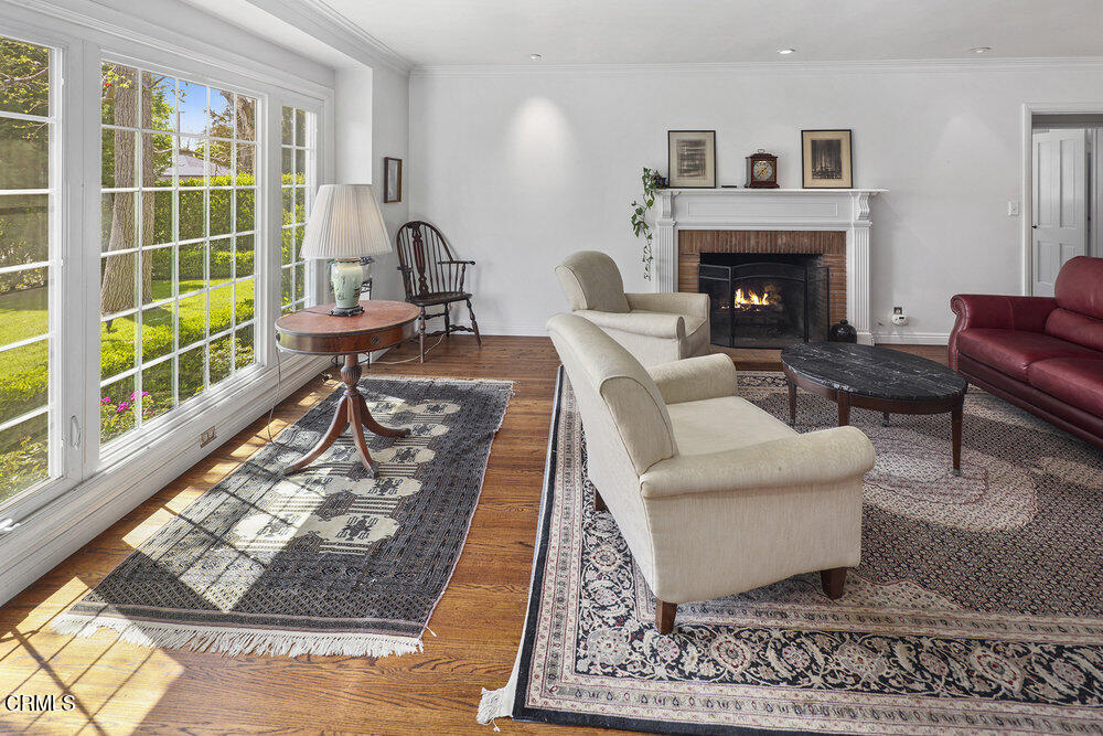 3657 Thorndale Road Pasadena, CA 91107 - Photo 4 of 44 a living room with furniture a rug and a fireplace