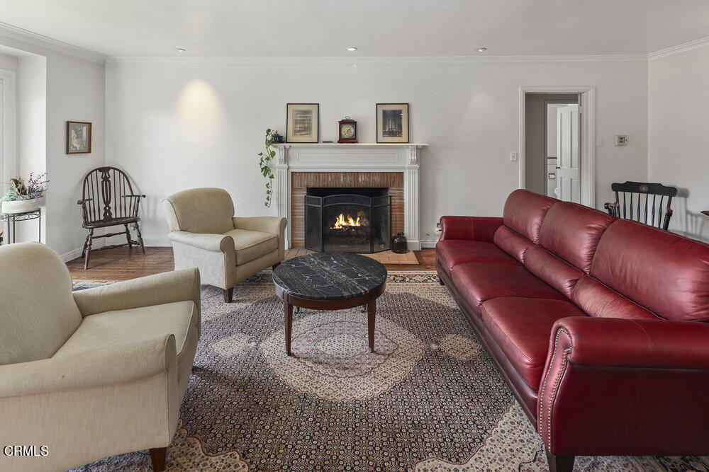 3657 Thorndale Road Pasadena, CA 91107 - Photo 7 of 44 a living room with furniture a rug and a fireplace