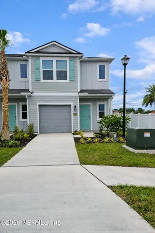 a front view of a house with yard and green space