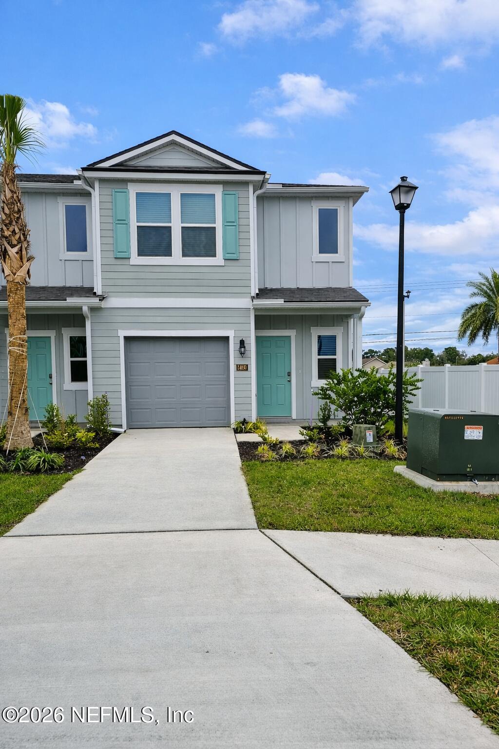 a front view of a house with yard and green space