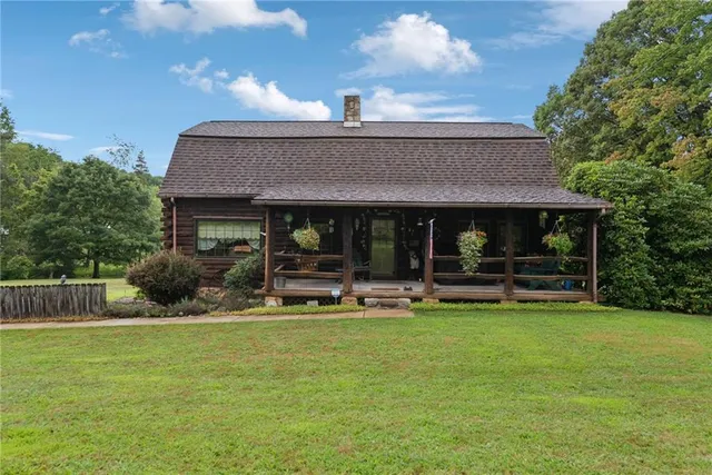 a view of a house with backyard porch and sitting area