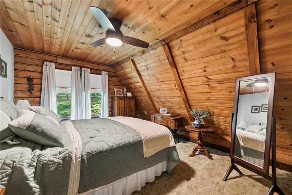 123 Crestview Drive Acme, PA 15610 - Photo 16 of 20 a bed sitting in a bedroom next to a window