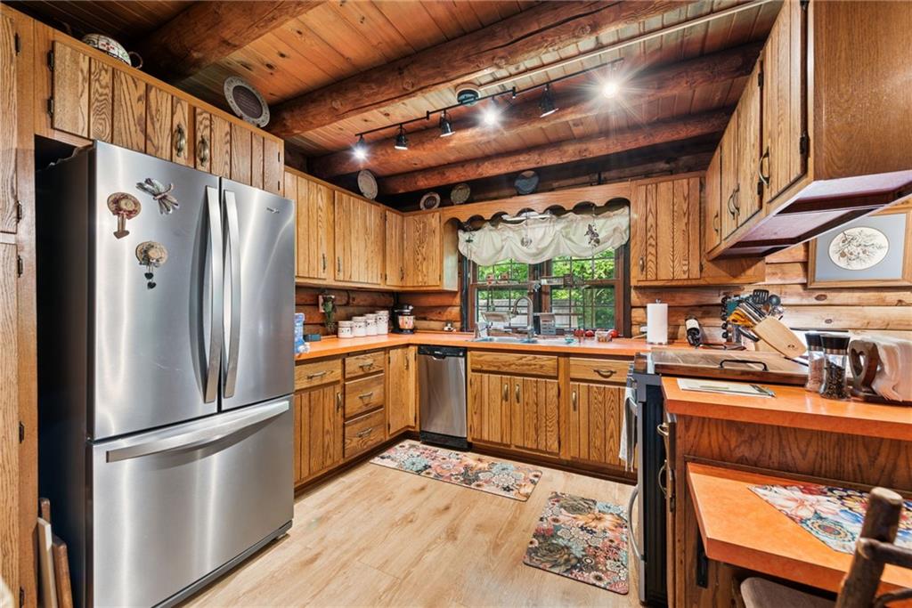 123 Crestview Drive Acme, PA 15610 - Photo 5 of 20 a kitchen with stainless steel appliances granite countertop a refrigerator a sink dishwasher a stove and white countertops with cabinets