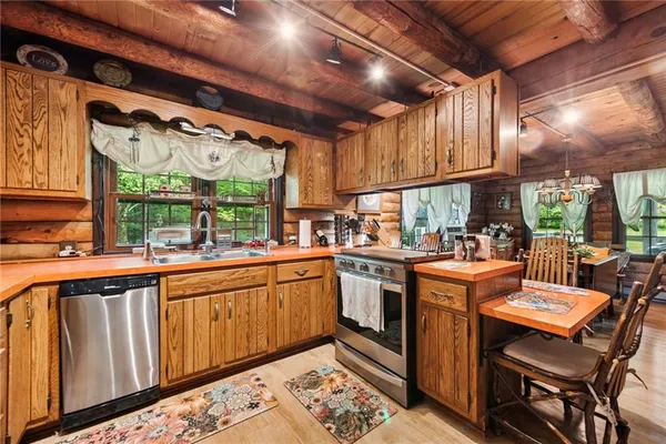 a open kitchen with stainless steel appliances granite countertop a sink and cabinets
