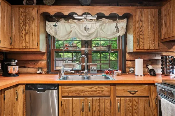 a kitchen with a sink and a stove next to a cabinet