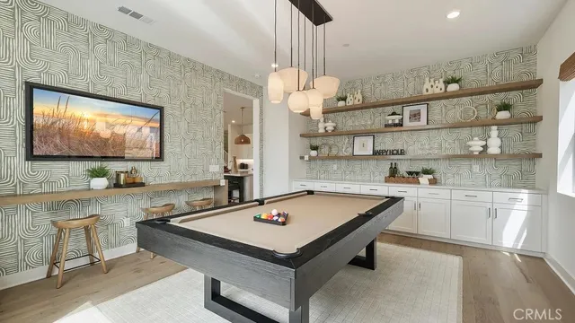 a room with pool table and flat screen tv