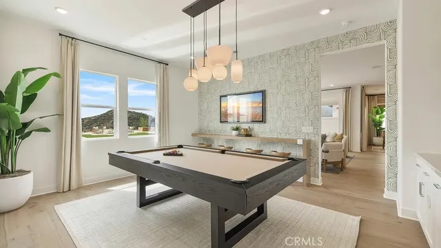 a room with pool table and windows