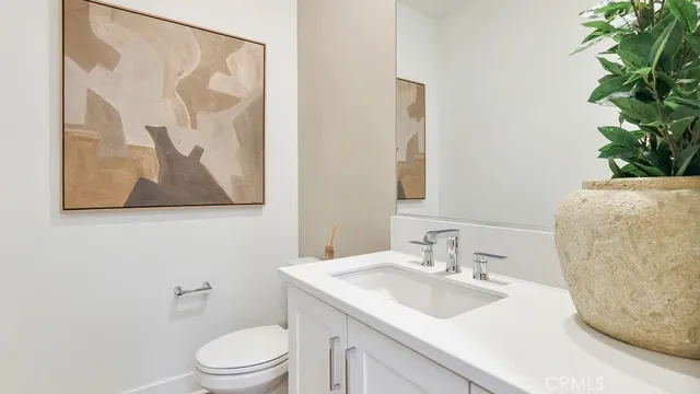 a bathroom with a toilet a sink and a mirror