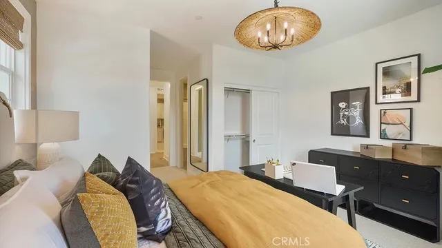 a bed room with a bed and a chandelier