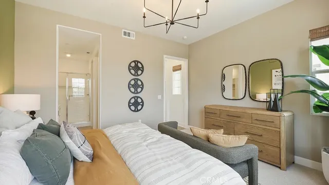 a bedroom with a bed a dresser and with potted plants