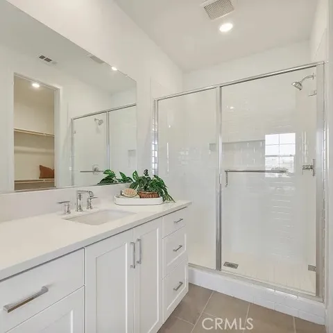 a bathroom with a shower sink and mirror