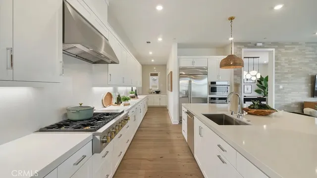a kitchen with stove a sink and cabinets