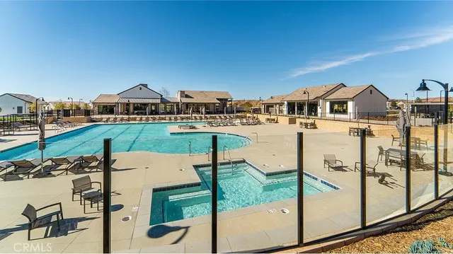 a view of a houses with a big yard and potted plants