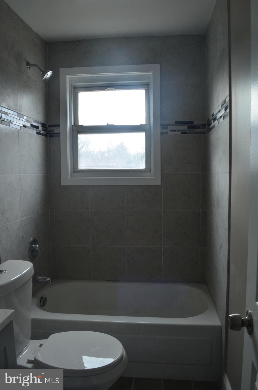 4952 Brookwood Road Baltimore, MD 21225 - Photo 8 of 13 a bathroom with a toilet and a bath tub