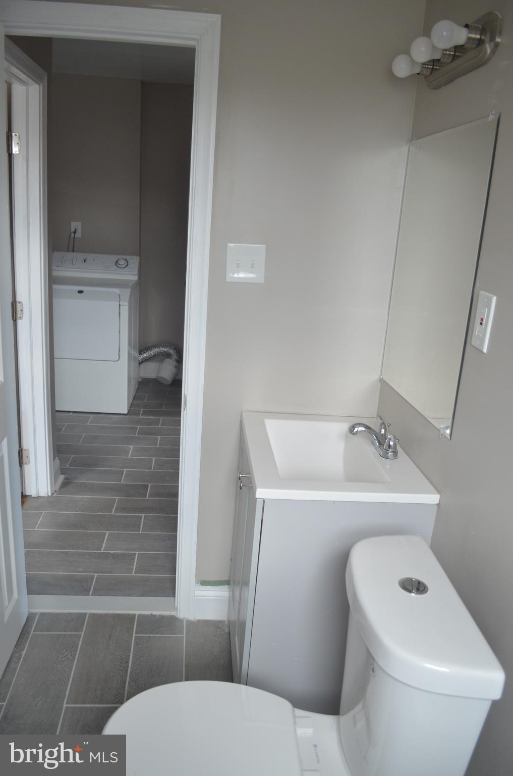 4952 Brookwood Road Baltimore, MD 21225 - Photo 9 of 13 a bathroom with a sink and toilet