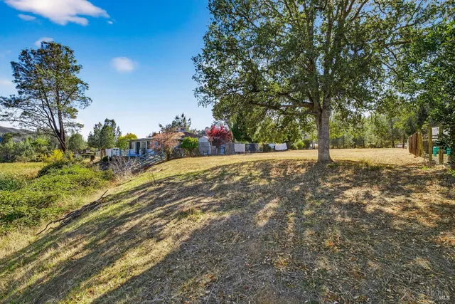 a view of a road with a house in the background