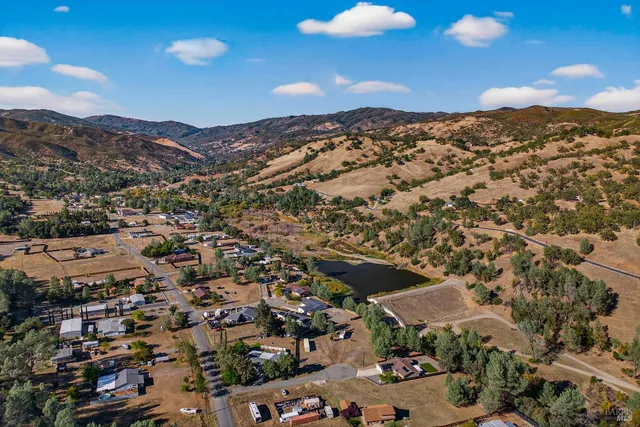 an aerial view of residential houses with outdoor space