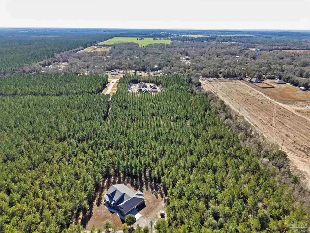 an aerial view of a house with a yard